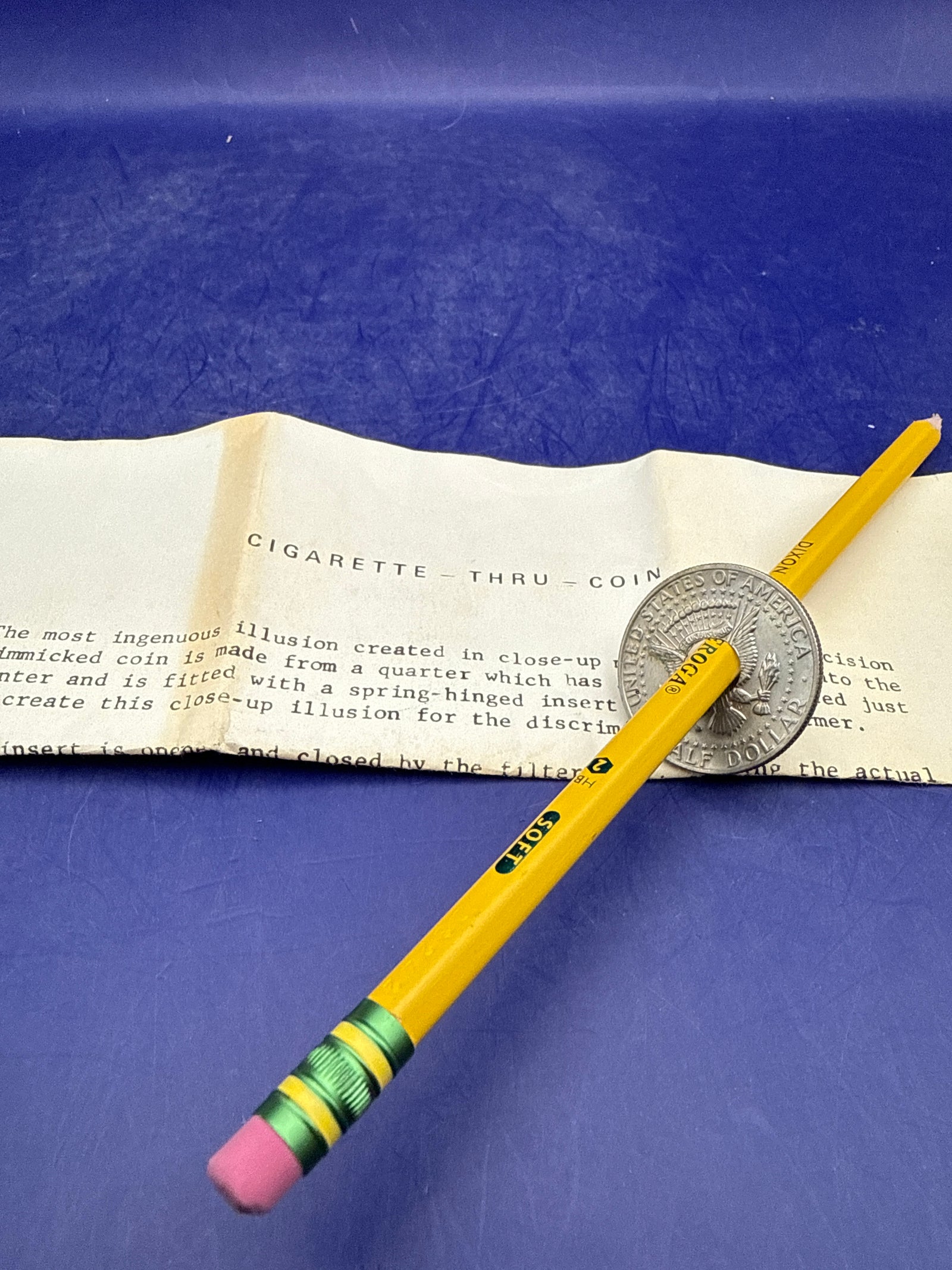 Cigarette / Pencil thru Coin - half dollar - ESTATE