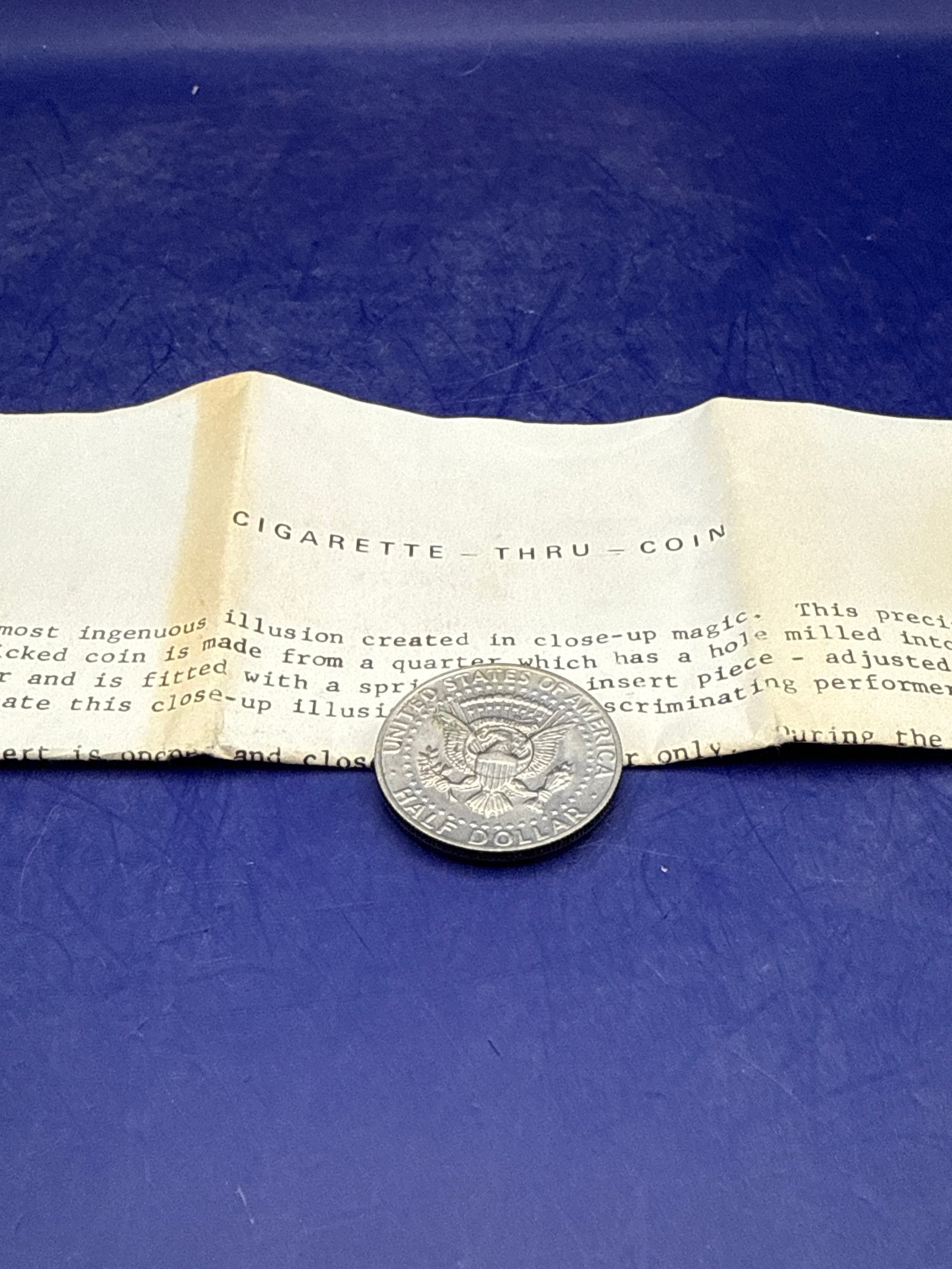 Cigarette / Pencil thru Coin - half dollar - ESTATE